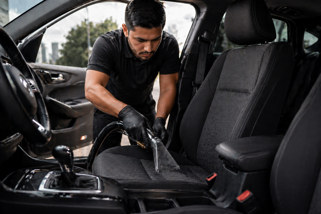 Professional performing interior car detailing Sacramento extraction cleaning on vehicle seats