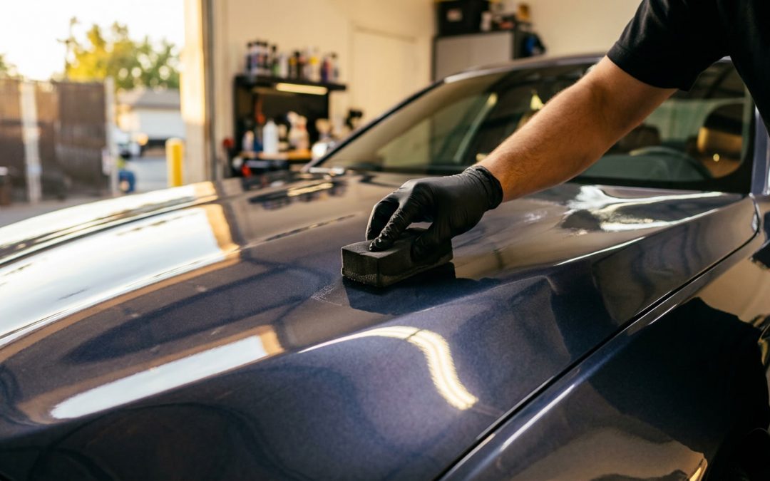 Technician applying professional ceramic coating sacramento in controlled environment